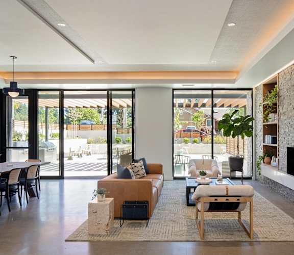 a living room with a stone fireplace and a couch and a table