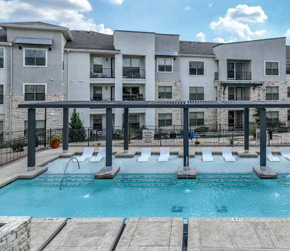 swimming pool with aqua tanning ledge at The Allure apartments