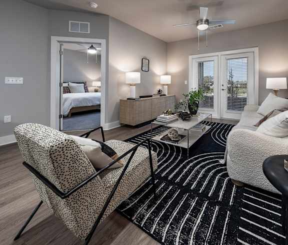 A living room with a couch, chair, and two lamps at The Waverly at Winter Haven Apartments, Winter Haven, 33884