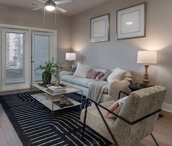 A living room with a couch, chair, and two lamps at The Waverly at Winter Haven Apartments, Winter Haven, 33884