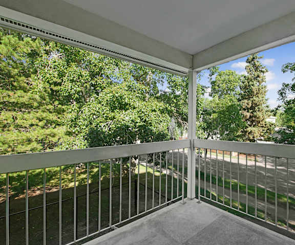 A balcony with a view of the street and trees at Gateway Gardens. 