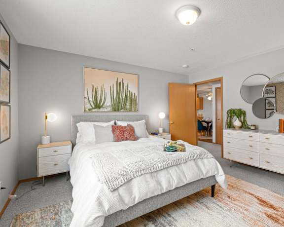 a bedroom with a large bed and a mirror
