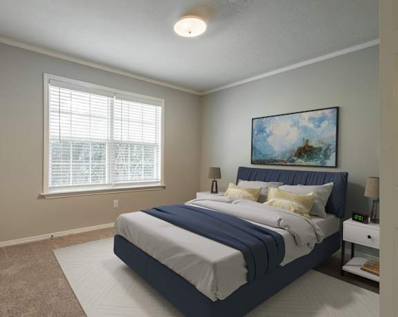 a bedroom with a large bed and two windows
