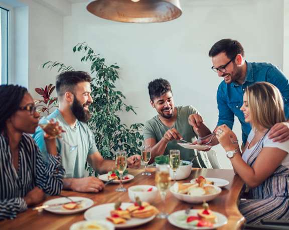 a group of people sitting around a table eating food