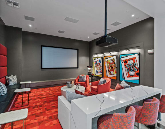 A modern room with a white table and red chairs. at Altis Twin Lakes Apartments, Kissimmee, FL 34744