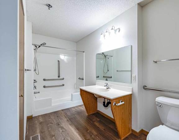 A white toilet sits next to a sink in a bathroom.