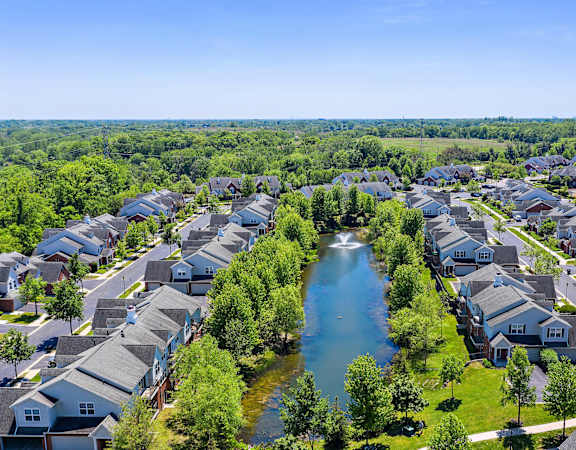 an aerial view of a neighborhood with a river in the middle at Cidermill Village, Michigan