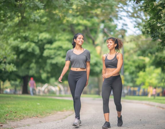 Two women walking in a park.