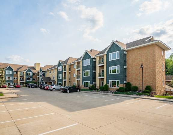 A parking lot in front of a row of townhouses.