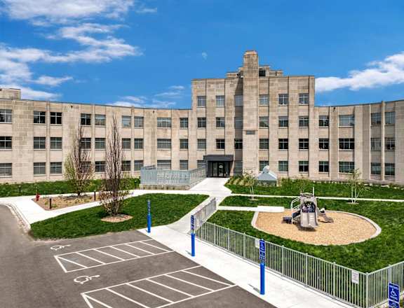 a large building with a playground in front of it
