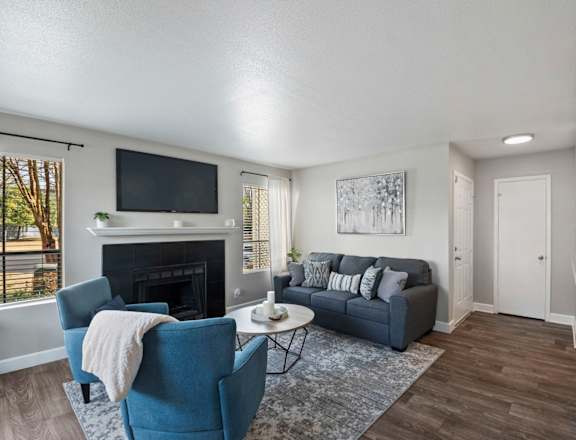 a living room with a fireplace and a tv