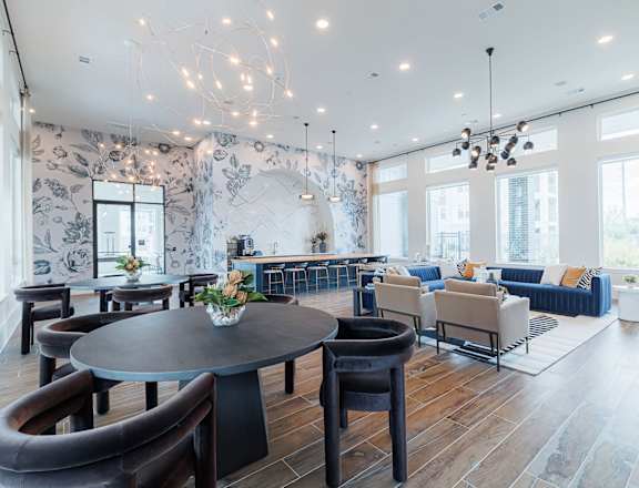 A modern living room with a round table and chairs.