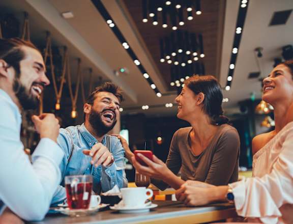 a group of people sitting at a table in a restaurant
