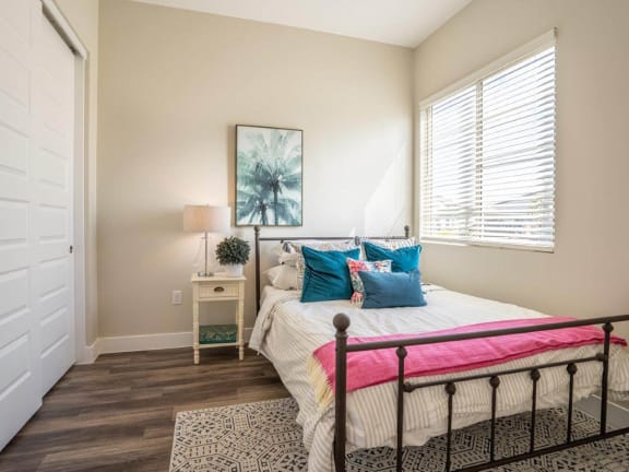 a bedroom with a bed and two windows