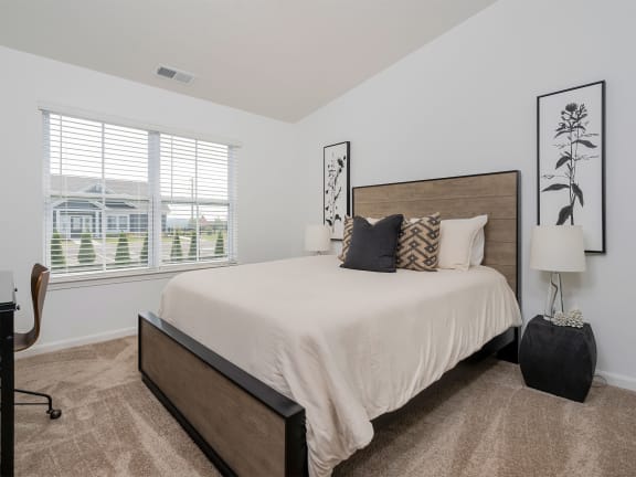 a bedroom with a bed and a desk with a chair