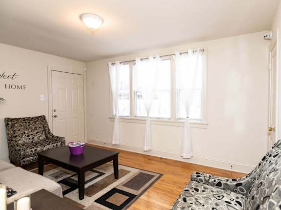 A living room with a couch, chair, and table.