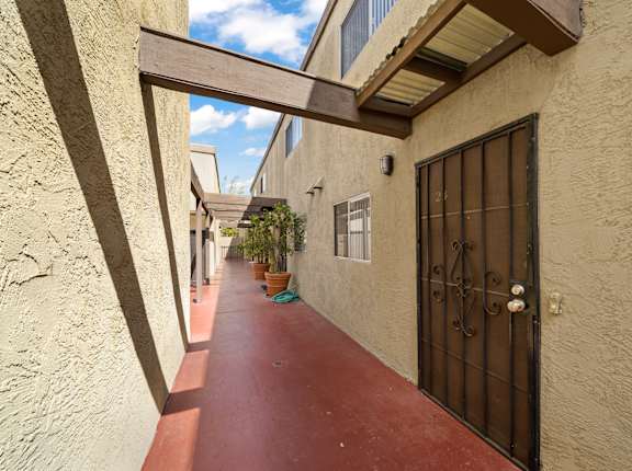 a long walkway leads to the front door of the home