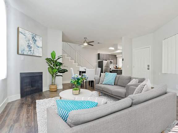 A living room with a grey couch and a fireplace at Alon Apartments, Los Angeles, CA, 90034