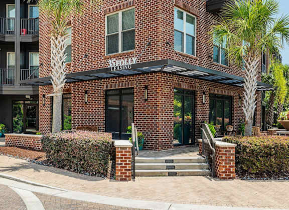 A brick building with a black awning and the words