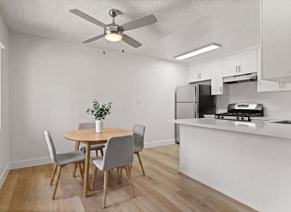 A dining room with a table and chairs.