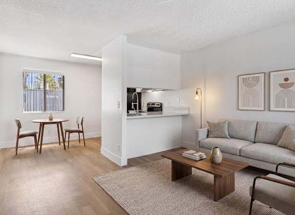 A living room with a dining table and chairs.