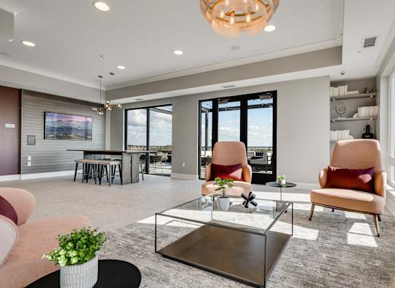 Community space with several seating areas and a walk out to an outdoor patio