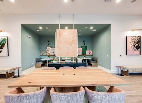 A conference room with a long table and chairs.