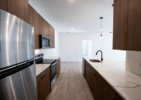 a kitchen with white cabinets and a granite counter top