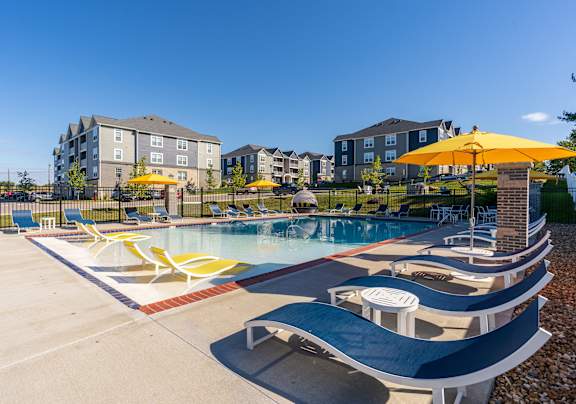 our apartments have a resort style pool with lounge chairs and umbrellas