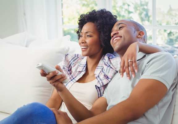 Couple Sitting on Sofa Together Smiling at Landing at Round Rock, Texas, 78681