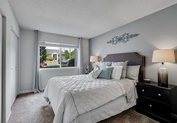 Carpeted Bedroom Featuring Large Windows