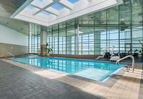 A large indoor swimming pool with a skylight above it.