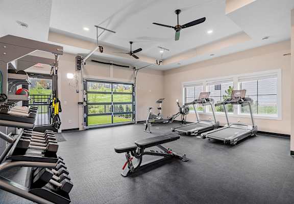 a gym with treadmills and other exercise equipment