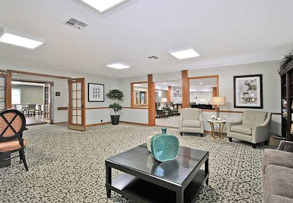 a living room with couches and chairs and a table