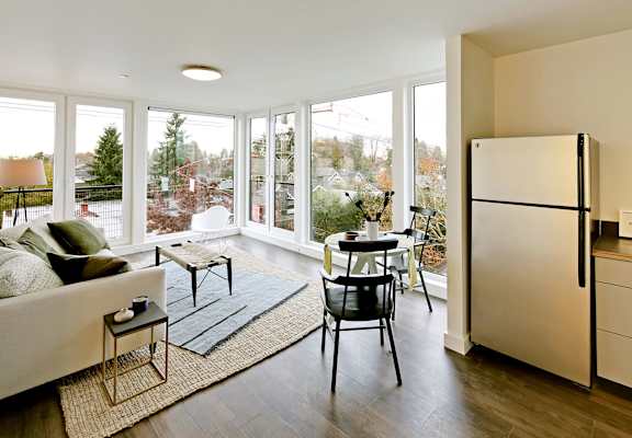 a living room with a couch and a table and a refrigerator  at 19th & Mercer, Seattle, Washington