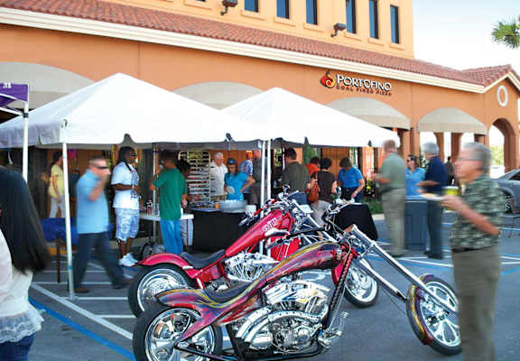 Local chopper enthusiasts and assorted vendors celebrating an outdoor event at Portofino Plaza