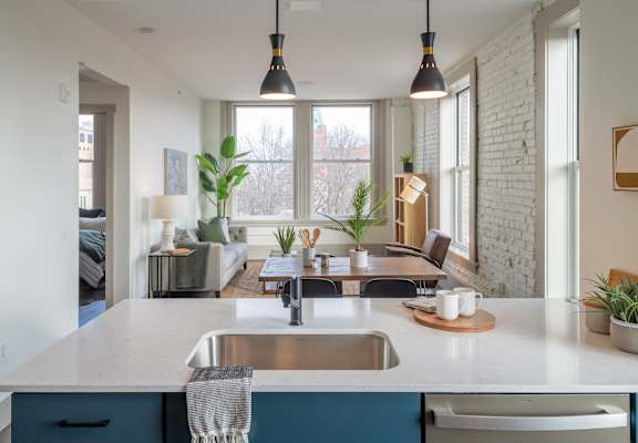 a kitchen with a sink and large windows at The Nicholas, St Louis, Missouri