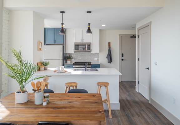 a kitchen and dining area in a 555 waverly unit at The Nicholas, St Louis, Missouri