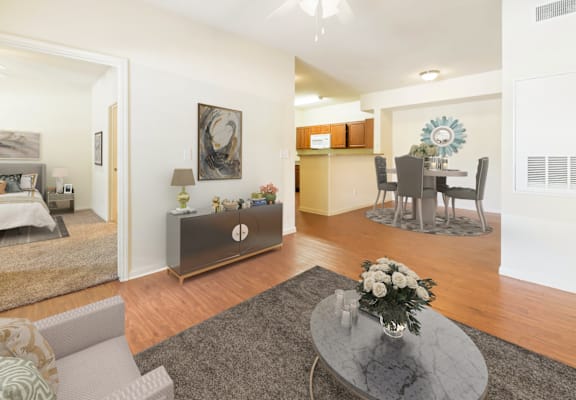 A living room with a grey coffee table and a grey sofa.