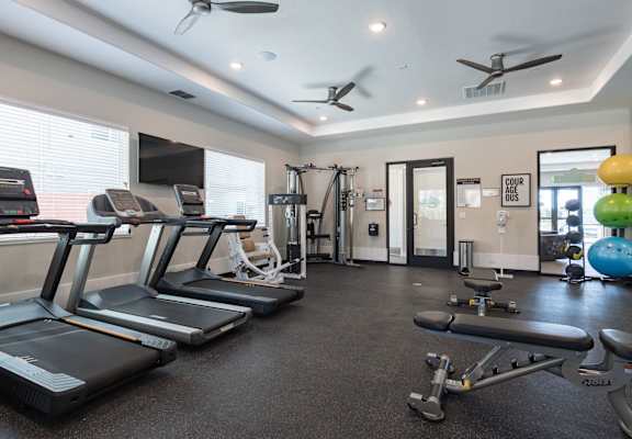 A gym with treadmills, weights, and exercise equipment. at Heritage Landing Apartments, Chico, CA, 95973