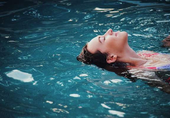 a woman swimming in a pool  at Baldwin Farms Apartments, Alabama