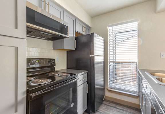 a kitchen with stainless steel appliances and a window