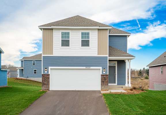 a blue and tan house with a garage door