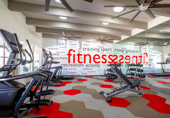 A gym with treadmills and a sign that says "fitness recreation activity".