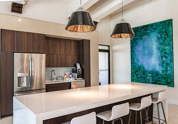 a kitchen with a large island and a green painting