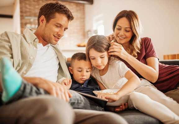 Family on Couch at Pembroke Pines Landing in Pembroke Pines, FL 33025