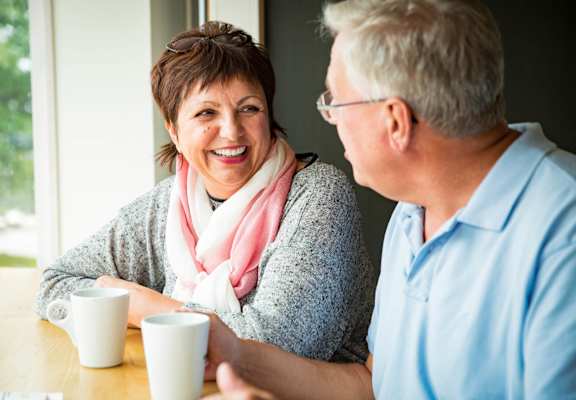 a man and a woman sitting at a table talking at Glen at Burnsville, Burnsville, 55337