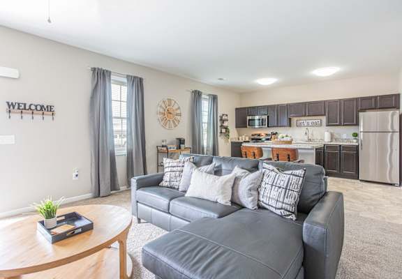 a living room with a couch and a kitchen