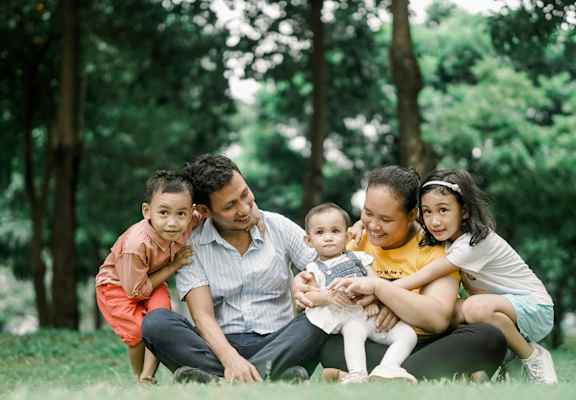 A family sitting in the grass