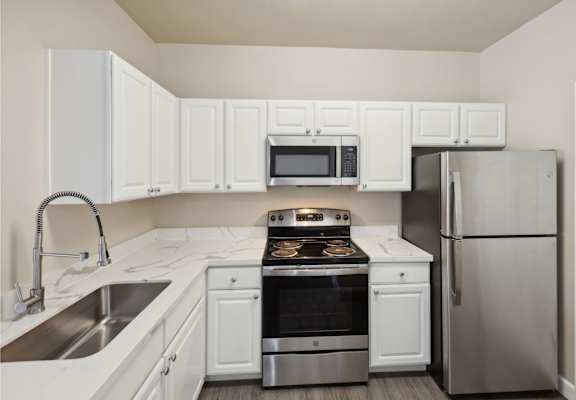 spacious kitchen with white cabinets and stainless steel appliances at Bridgeport Ranch apartments
